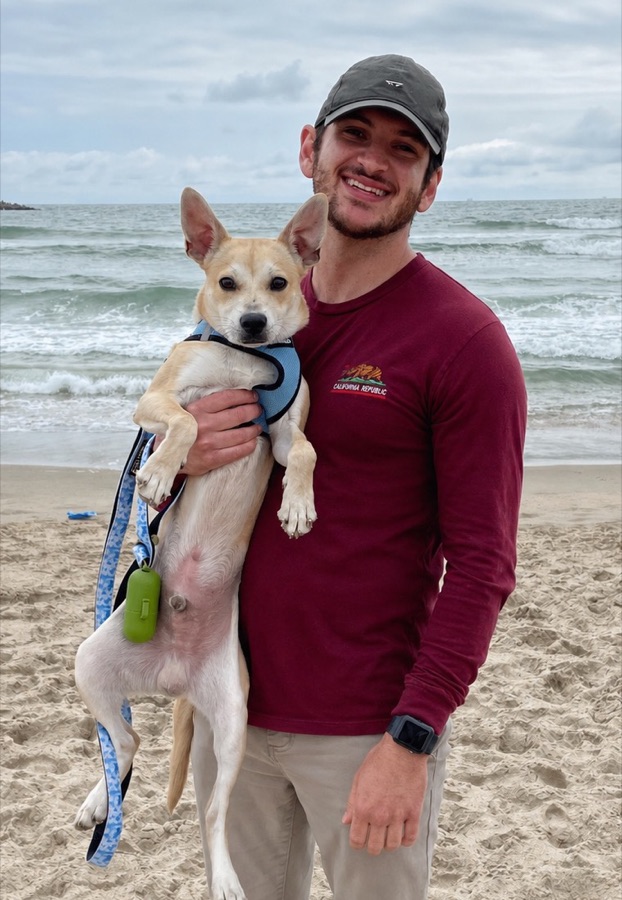 Jeremy Sparage holding his dog at the beach